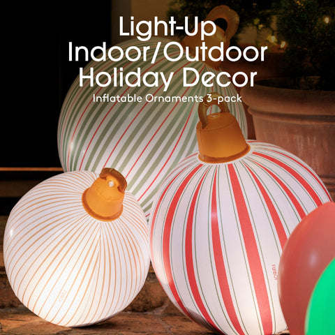 Inflatable holiday decor ornaments with striped patterns on a wooden surface