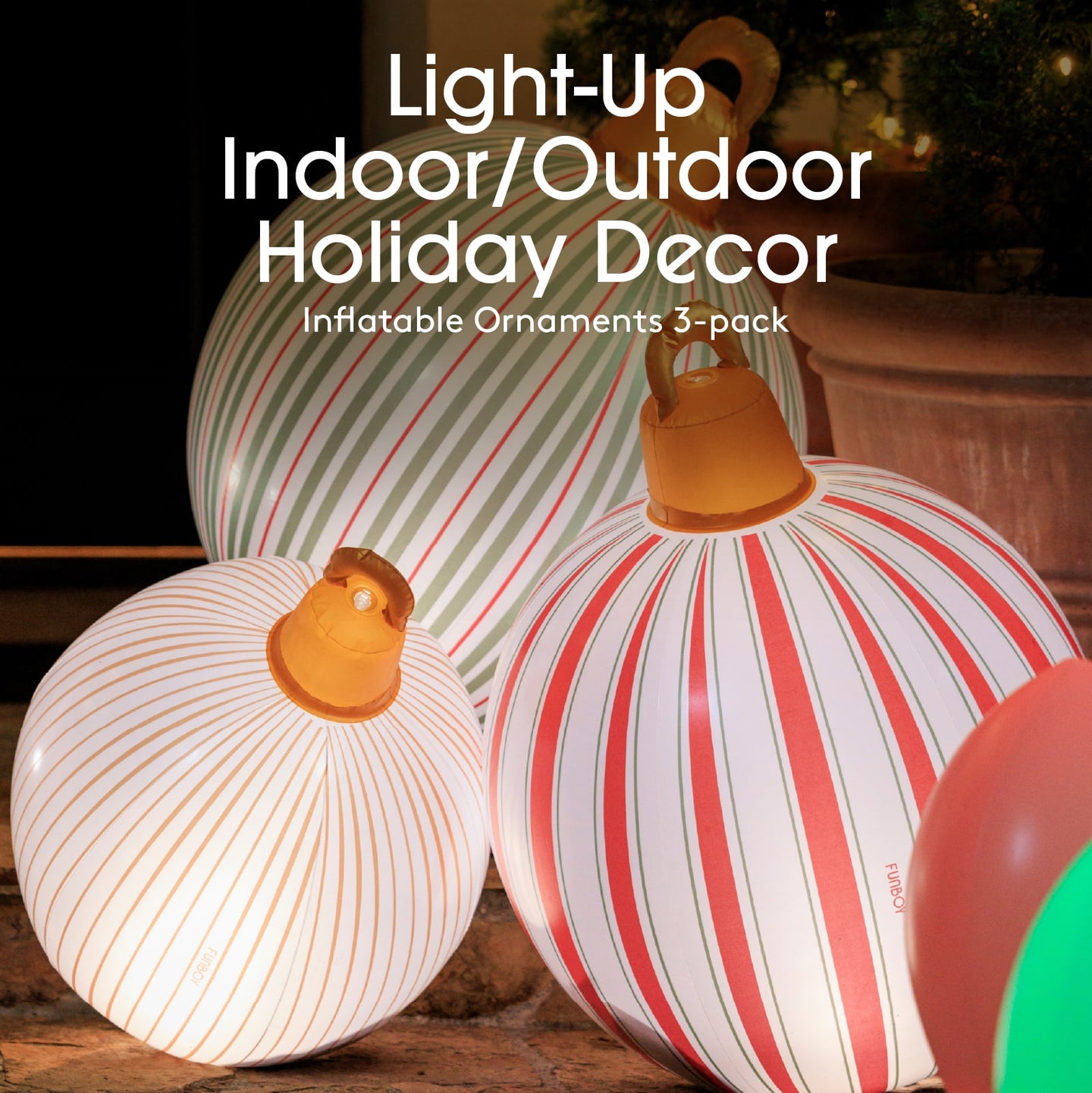 Inflatable holiday decor ornaments with striped patterns on a wooden surface.