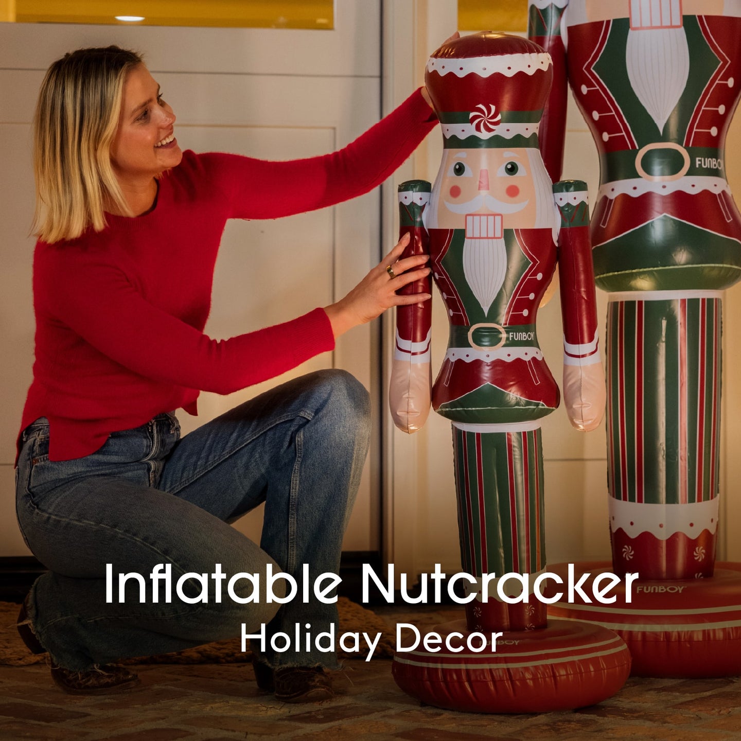 Woman with inflatable nutcracker decorations in a home setting