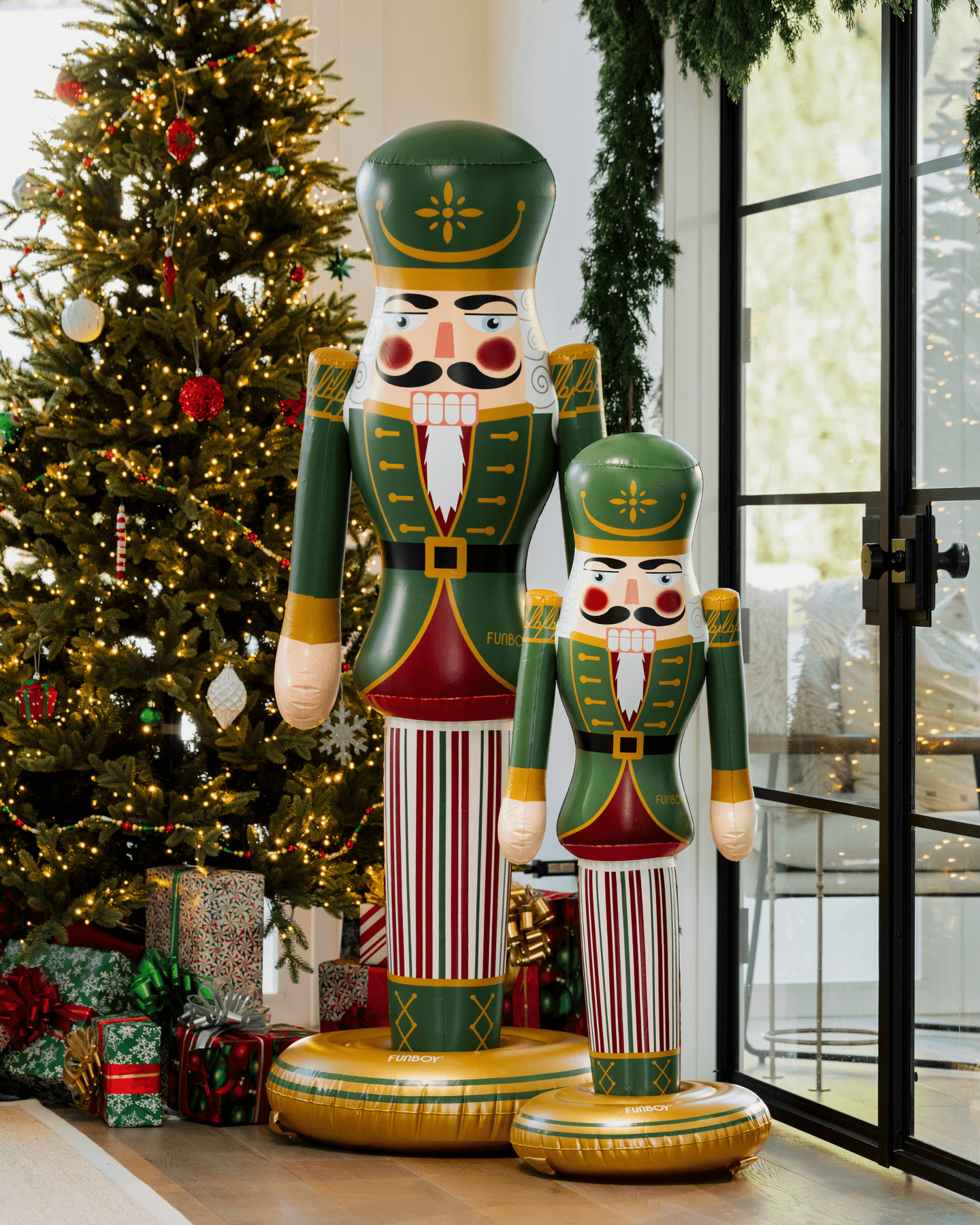 Decorative nutcrackers in front of a Christmas tree with presents.