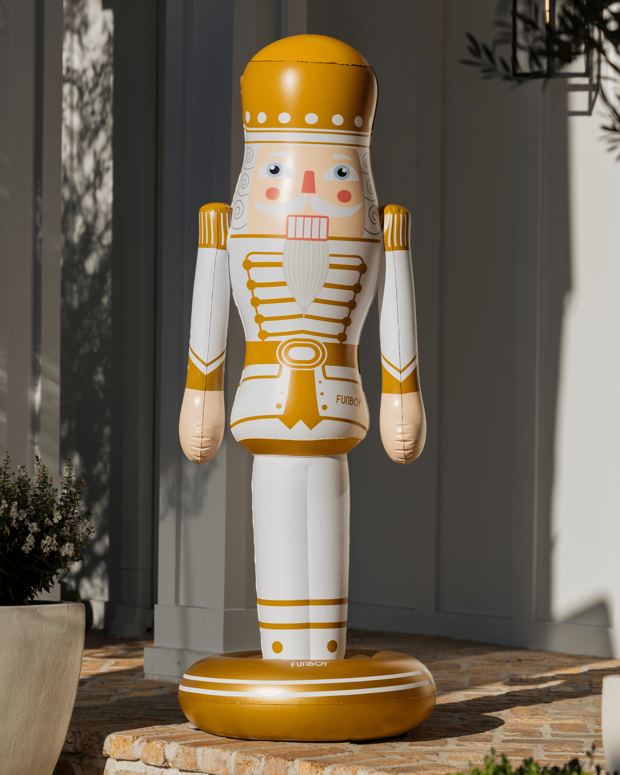 Decorative 5 foot inflatable nutcracker figure outdoors on a stone surface