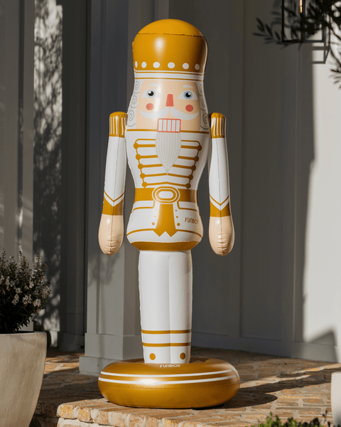 Decorative 5 foot inflatable nutcracker figure outdoors on a stone surface