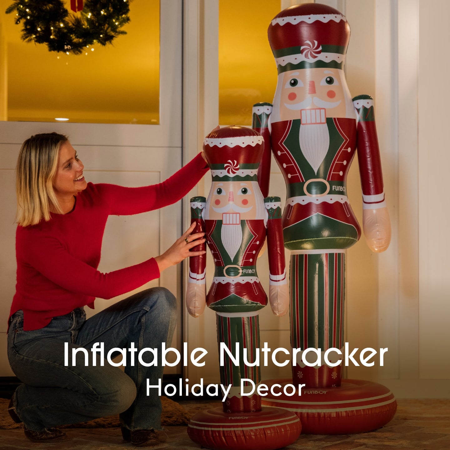 Woman with inflatable nutcracker decorations in a home setting