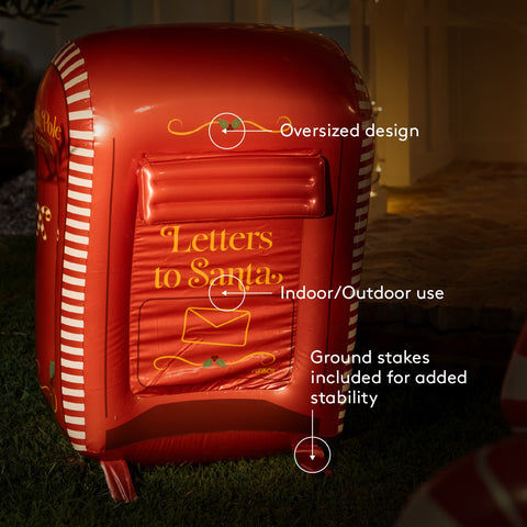 Red inflatable mailbox with 'Letters to Santa' text, featuring text labels on an outdoor background