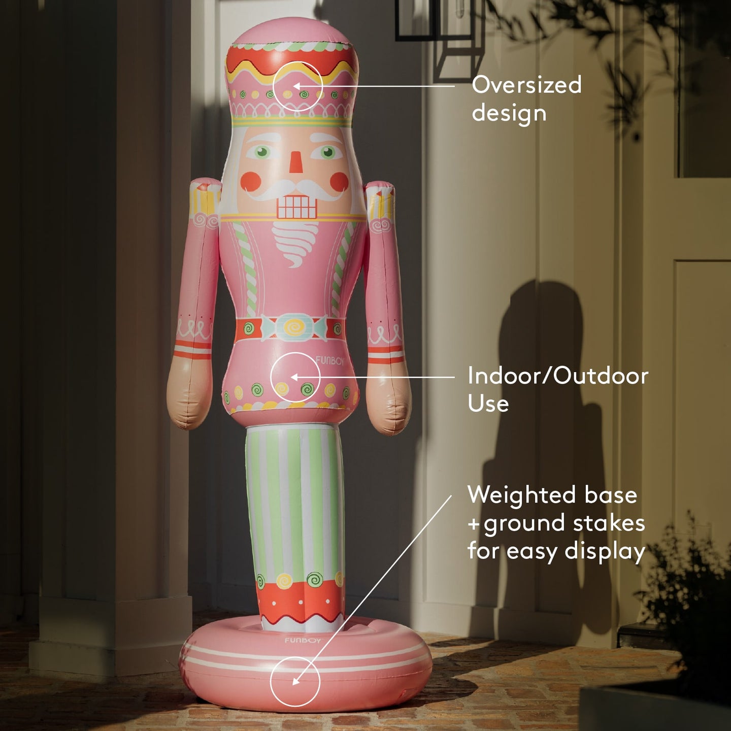 Decorative nutcracker figure with text indicating oversized design, indoor/outdoor use, and weighted base.