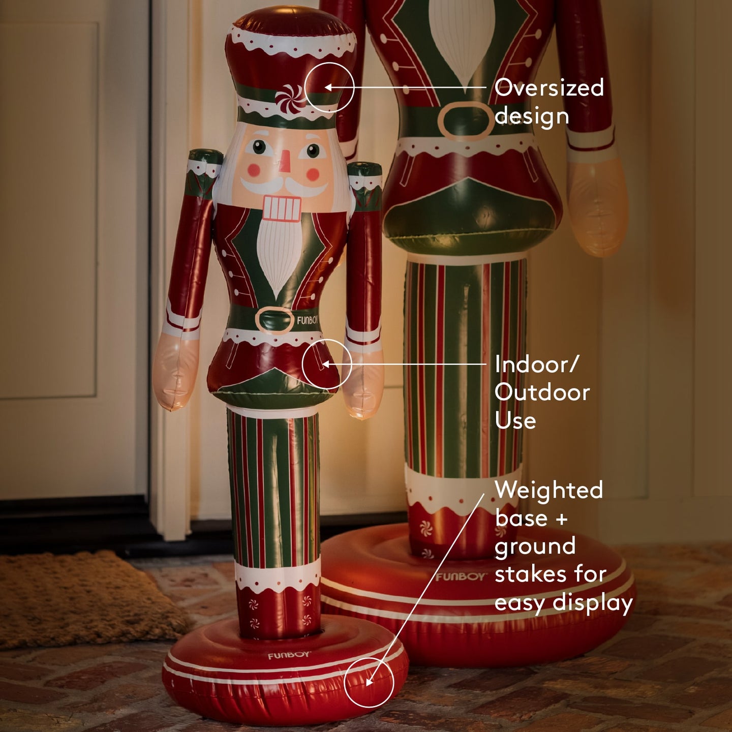 Two inflatable nutcrackers with text highlighting features on a tiled floor.