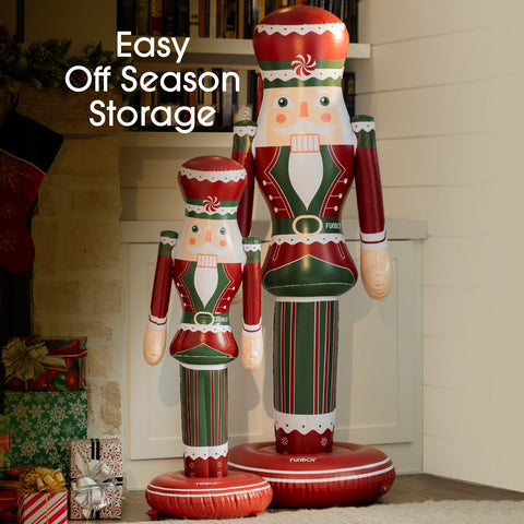 Two inflatable nutcrackers in red, green, and white standing in front of a fireplace with Christmas decorations.