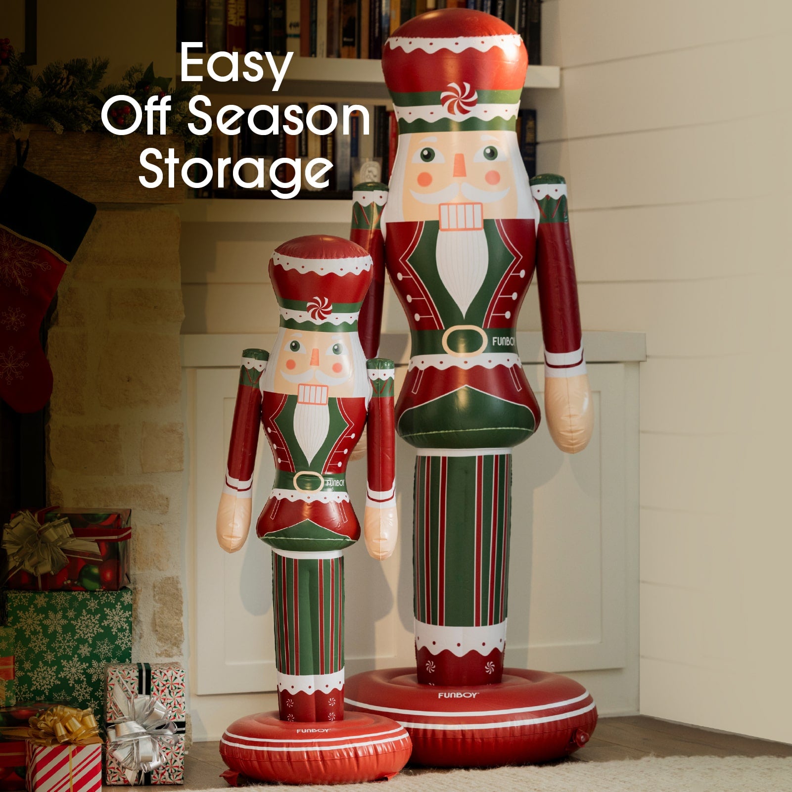 Two inflatable nutcrackers in red, green, and white standing in front of a fireplace with Christmas decorations