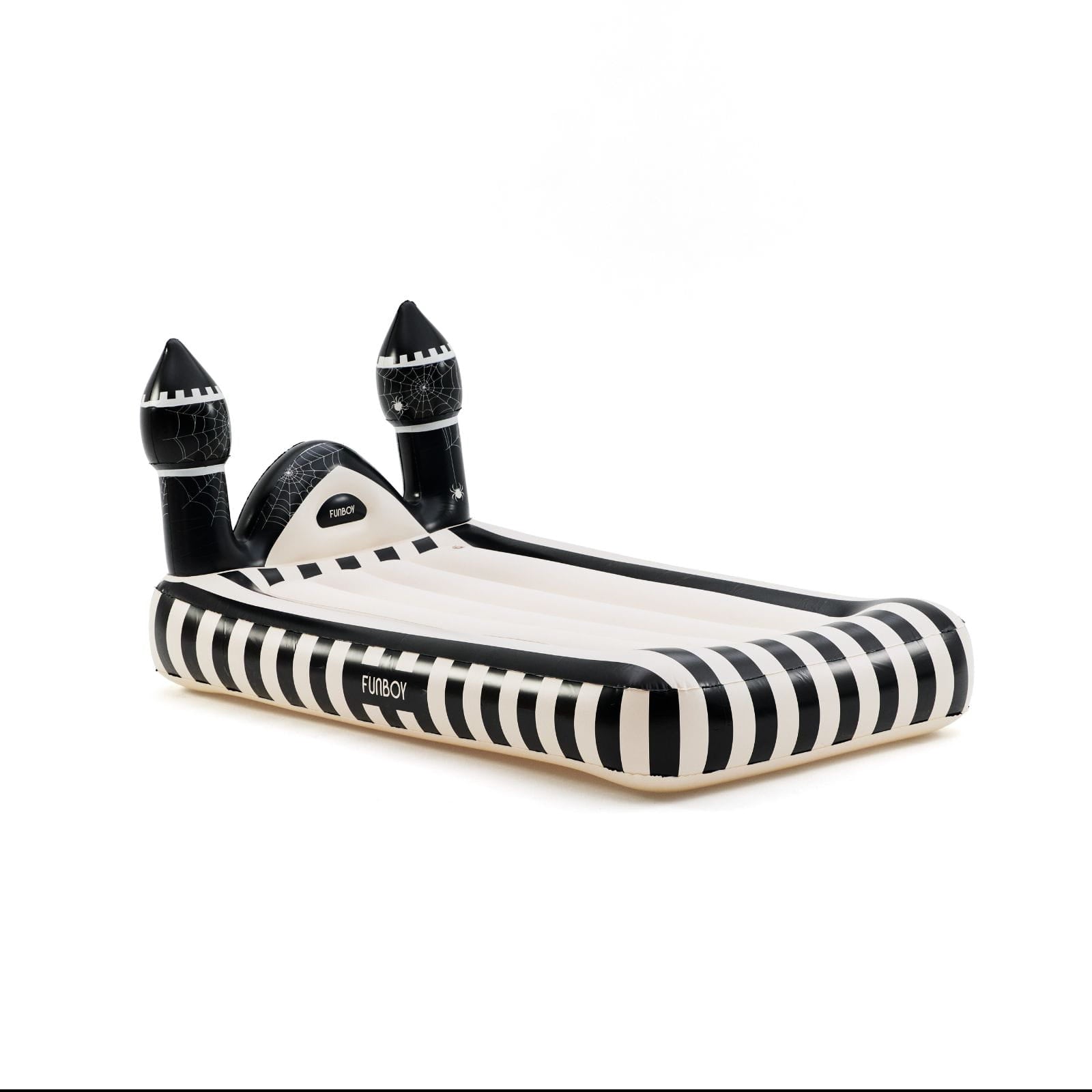 An inflatable castle-shaped pool float with black and white stripes, featuring two black turrets and a slide, shown on a plain white background.