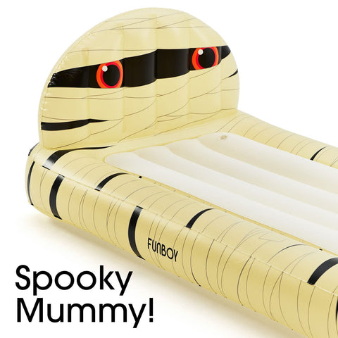 Inflatable mummy pool float with a pale yellow body, black bandage-style stripes, and red eyes, shown on a white background with the text 'Spooky Mummy!' in the lower left.