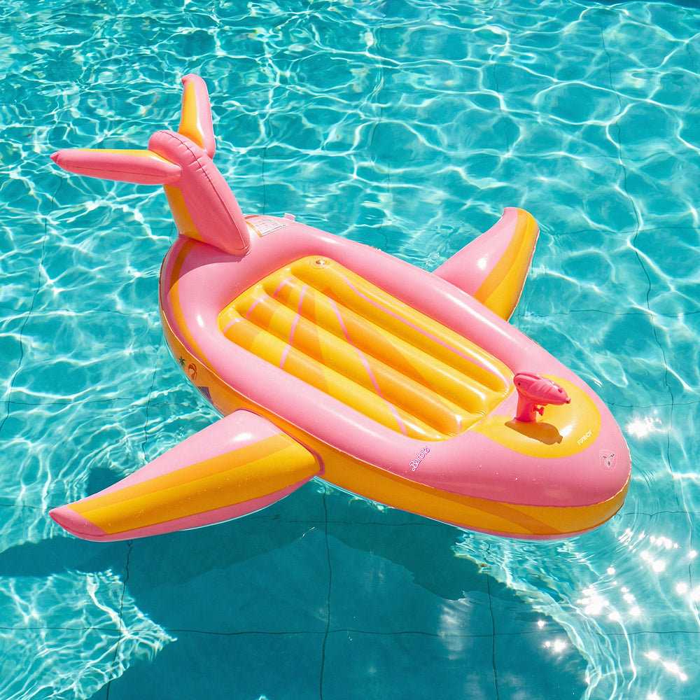 Inflatable Barbie x FUNBOY plane pool float in clear blue water