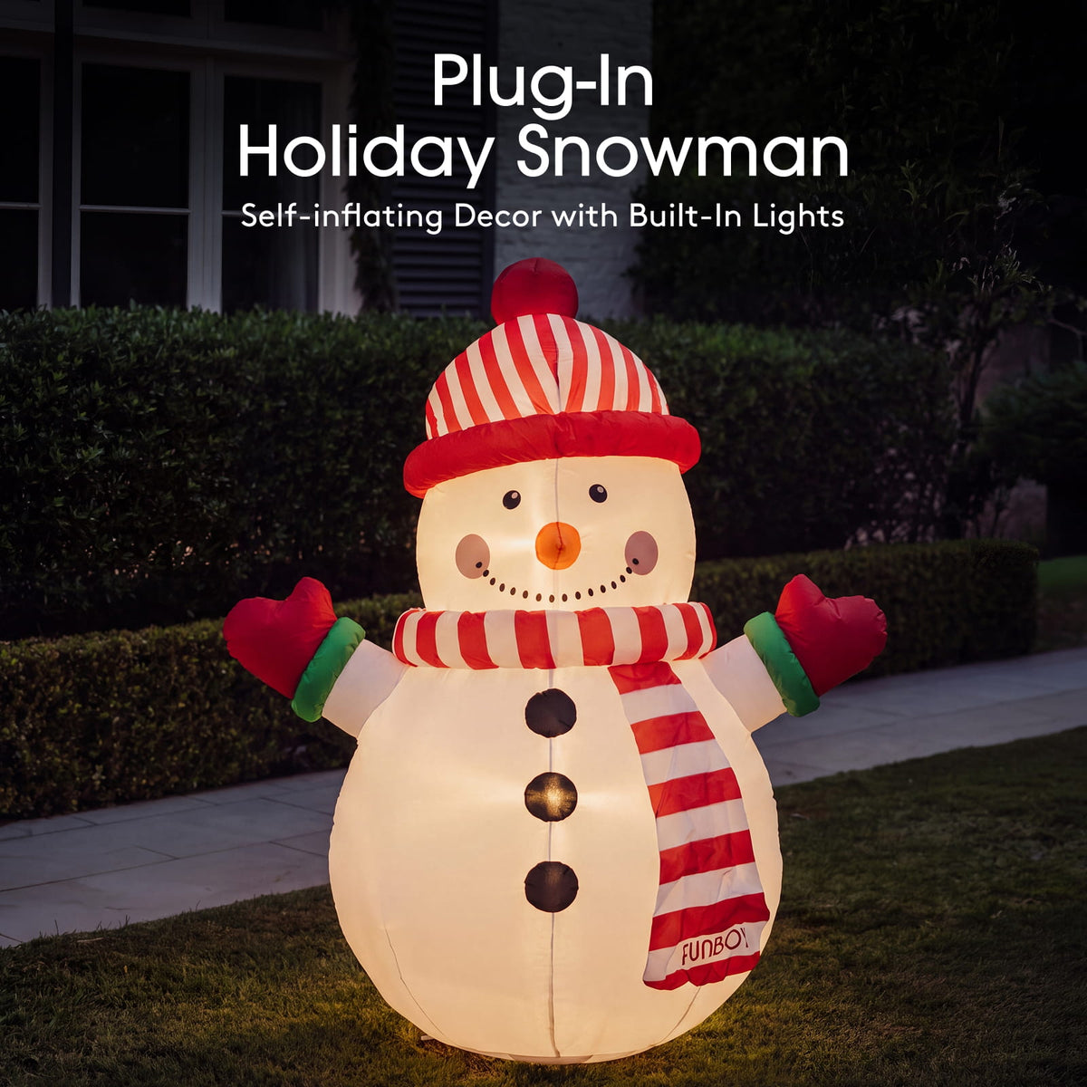 A large inflatable holiday snowman decoration stands on a lawn at night, glowing with built-in lights. The snowman wears a red-and-white striped hat, scarf, and mittens, with a small visible RUNO logo near the lower right of the scarf.