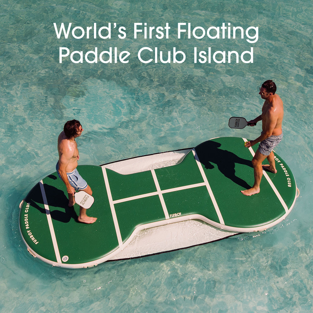 Floating paddle club island with two people playing paddle ball on a pool. Text reads: World First Floating  Paddle club Island.