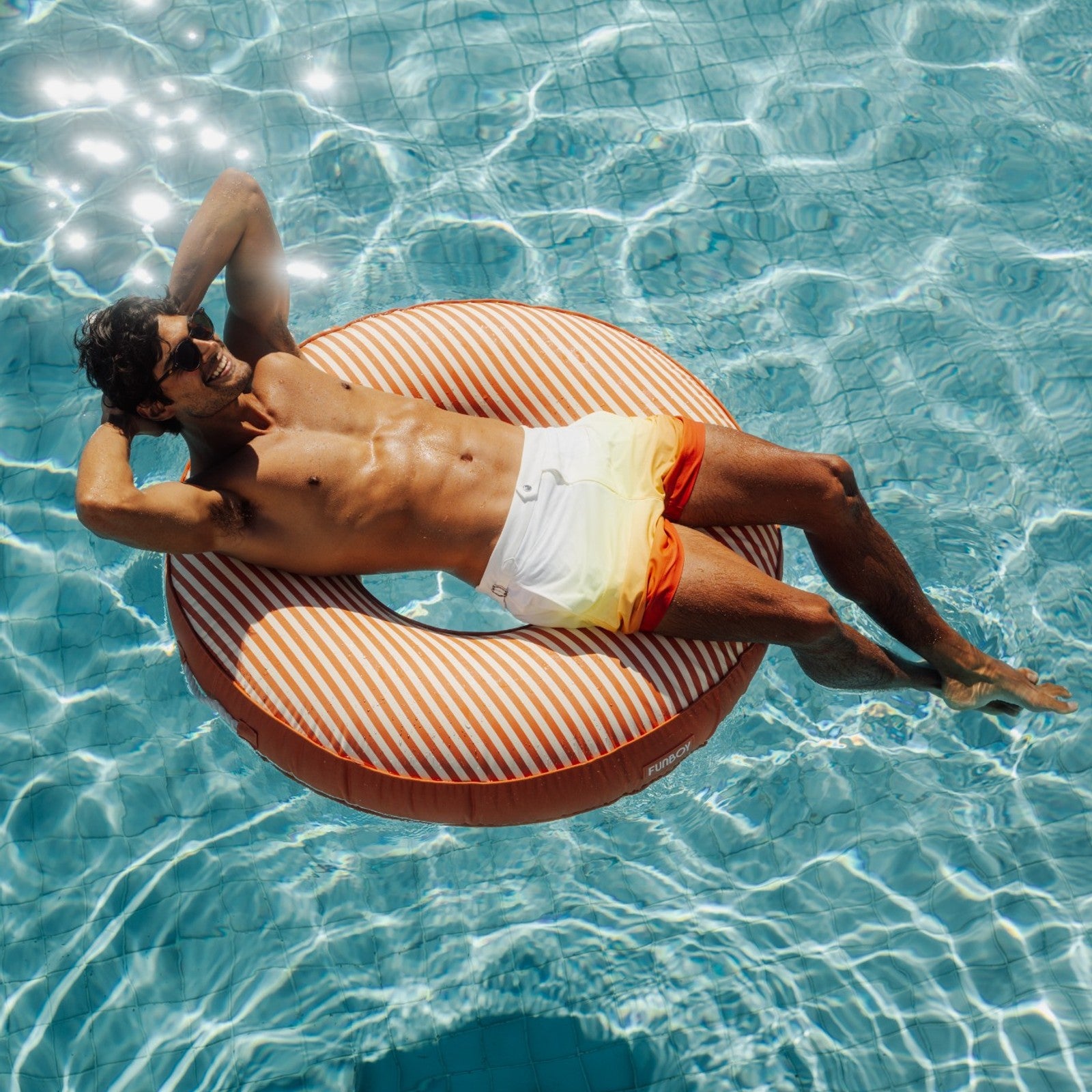 Fabric orange and white striped tube ring pool float for adults