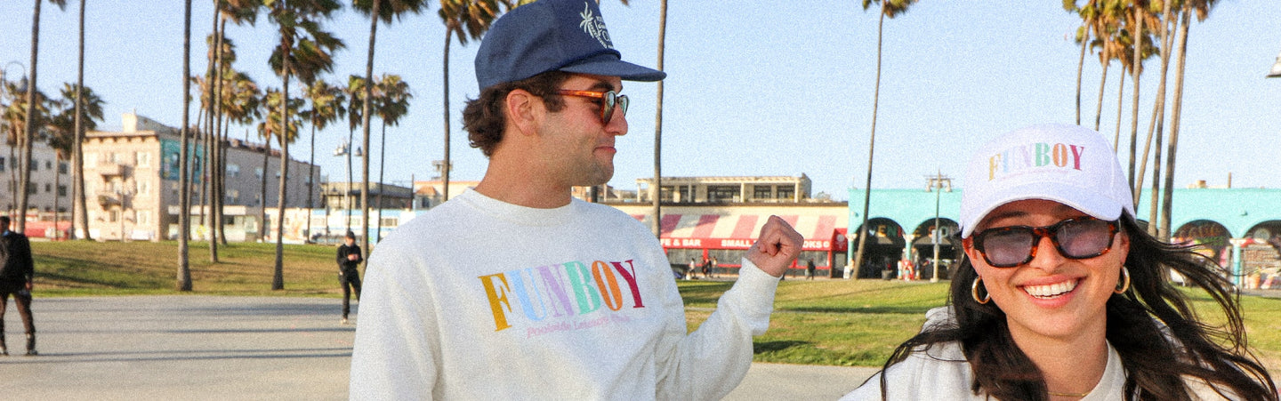 two people on the boardwalk wearing FUNBOY merch and apparel