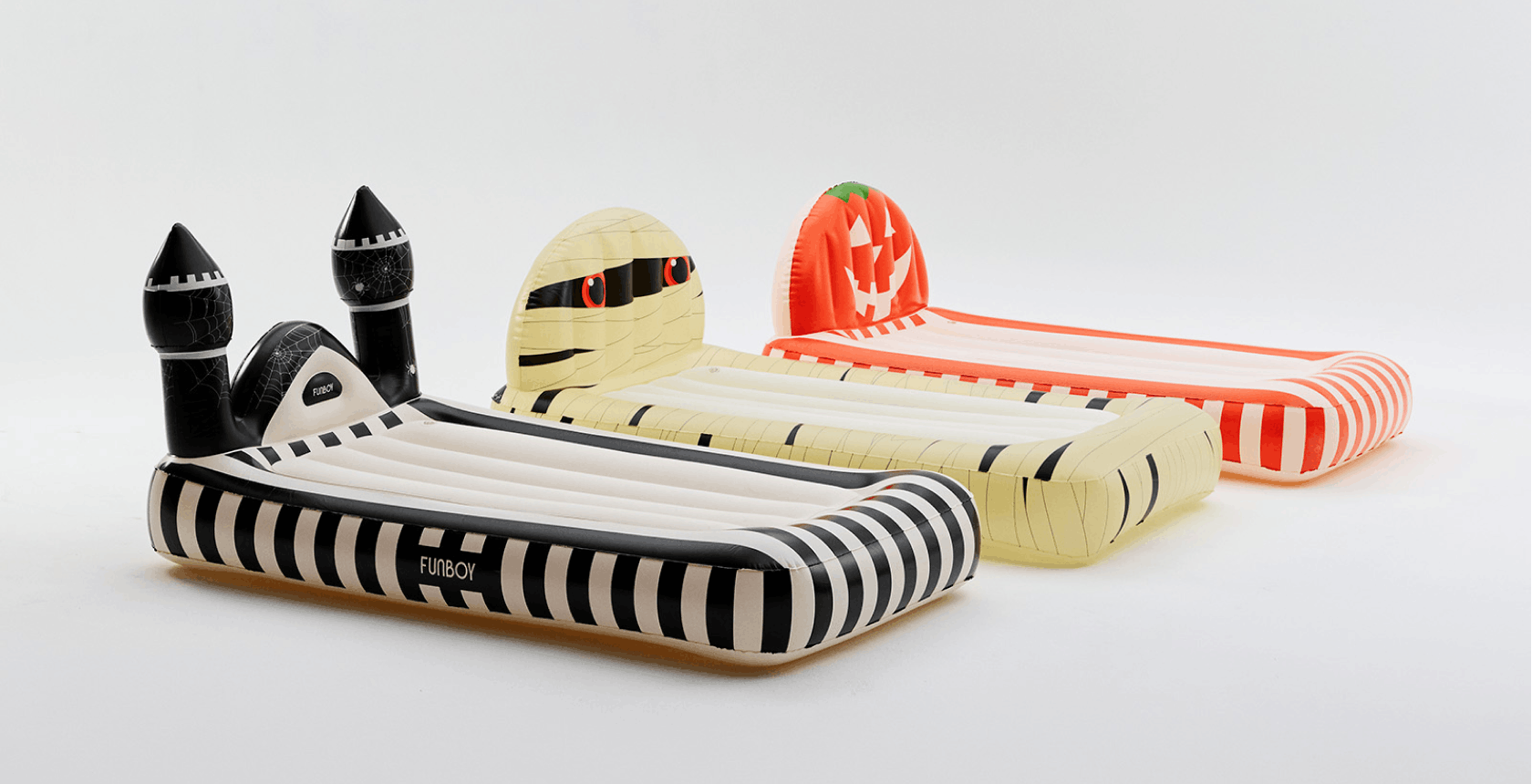 Three inflatable pool float beds with Halloween-themed designs, including a castle, a mummy, and a jack-o'-lantern, shown on a clean white background.
