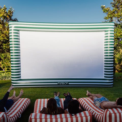 Green and white movie screen with pool floats