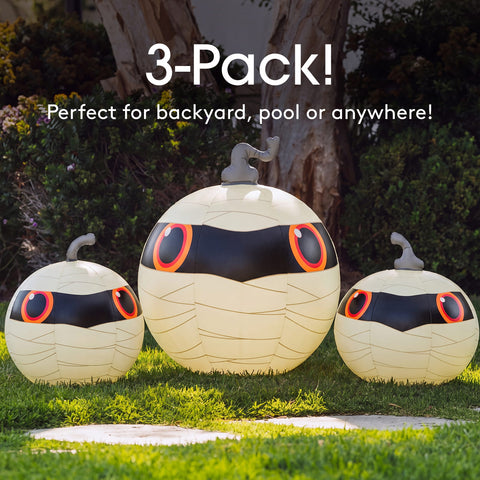Three mummy-themed outdoor pumpkin decorations displayed on grass in front of trees, with text reading '3-Pack! Perfect for backyard, pool or anywhere!'.