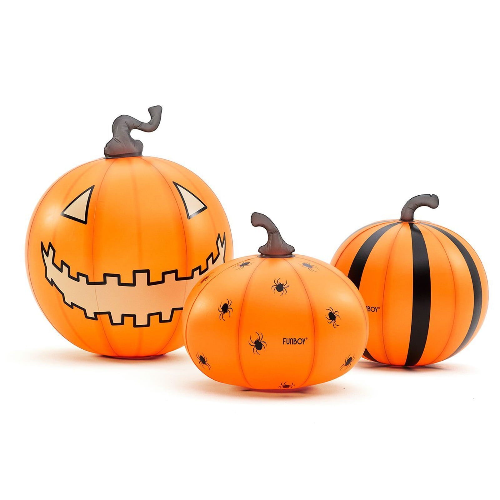 Three orange Halloween pumpkin decorations on a white background, including a large jack-o'-lantern with a carved face, a smaller pumpkin with spider prints, and a striped pumpkin.