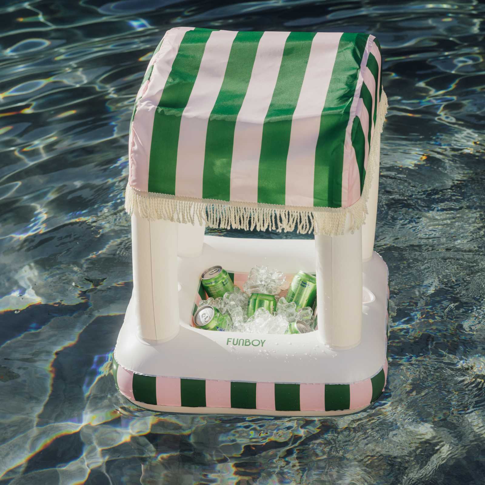 Inflatable cooler with green and white striped cover floating in water