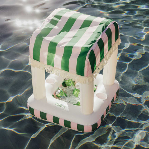 Inflatable cooler with green and white striped cover floating on water