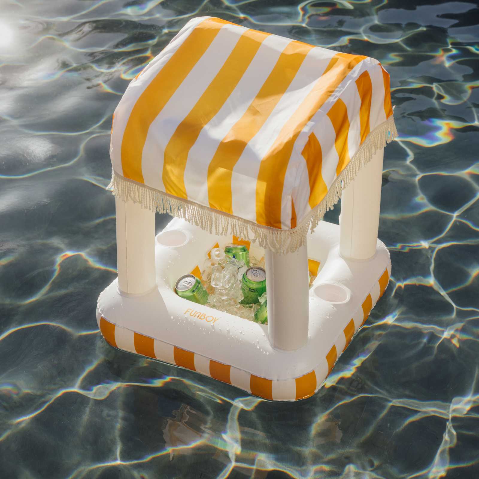 Inflatable cooler with yellow and white striped canopy floating in water