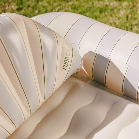 Inflatable lounge chair with striped pattern on grass