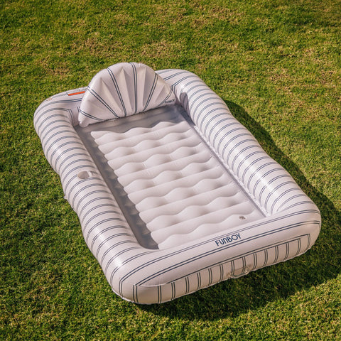 Inflatable pool with striped design on a grassy background
