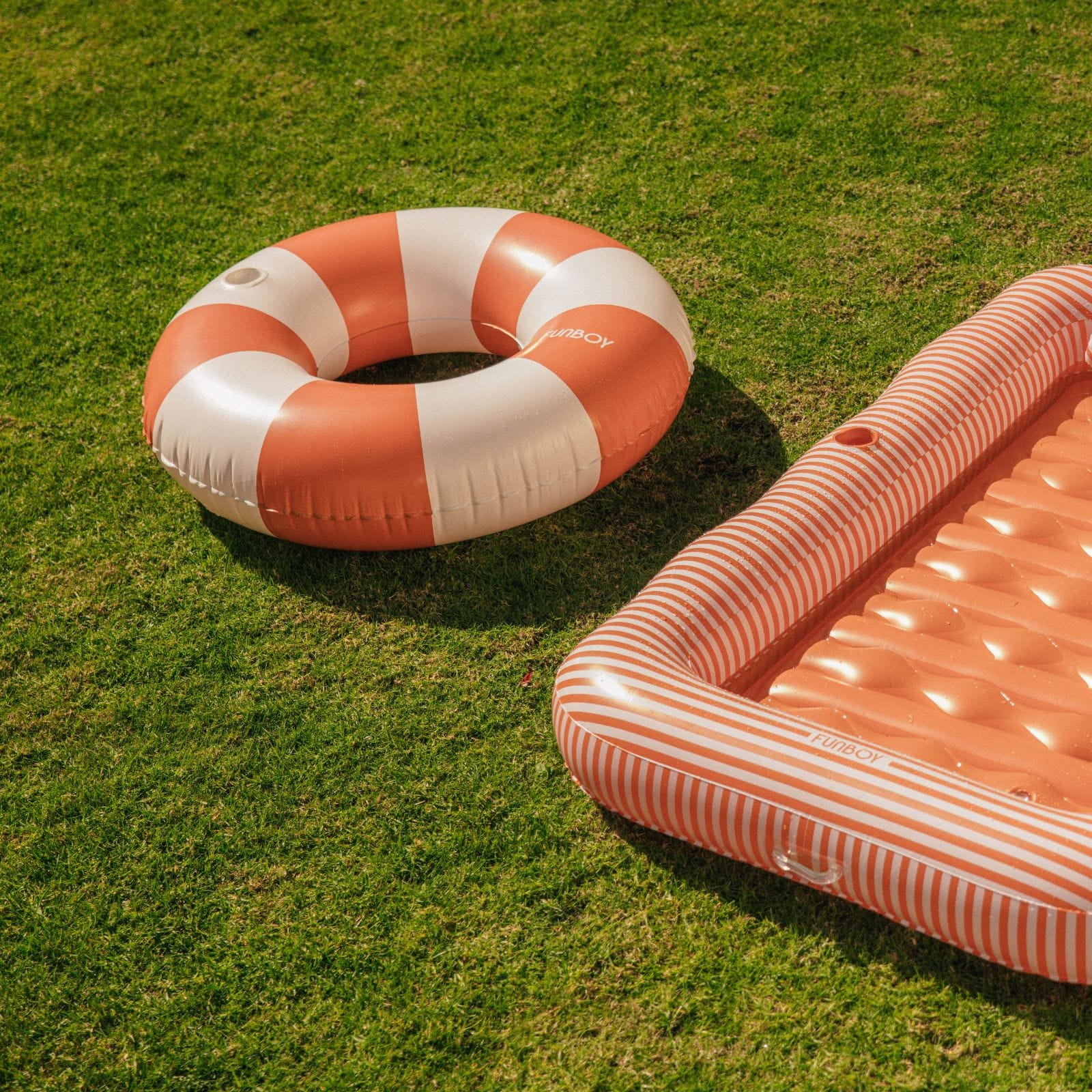 Inflatable life buoy and pool float on grass