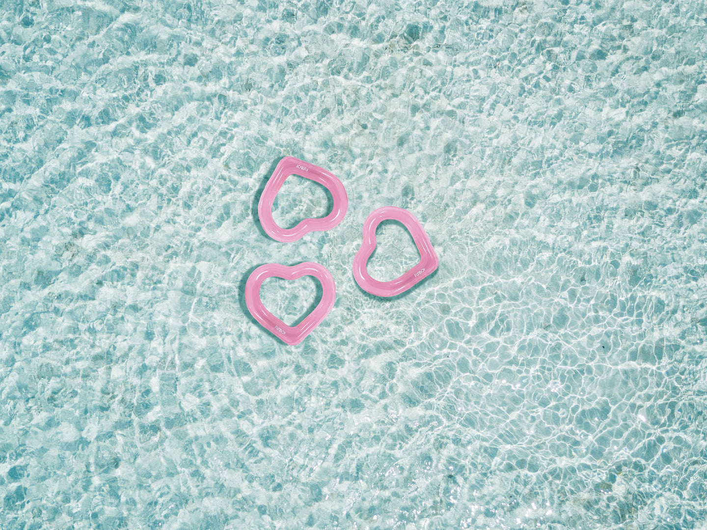 Funboy Clear Pink Heart Tubes Floating in Tropical Water